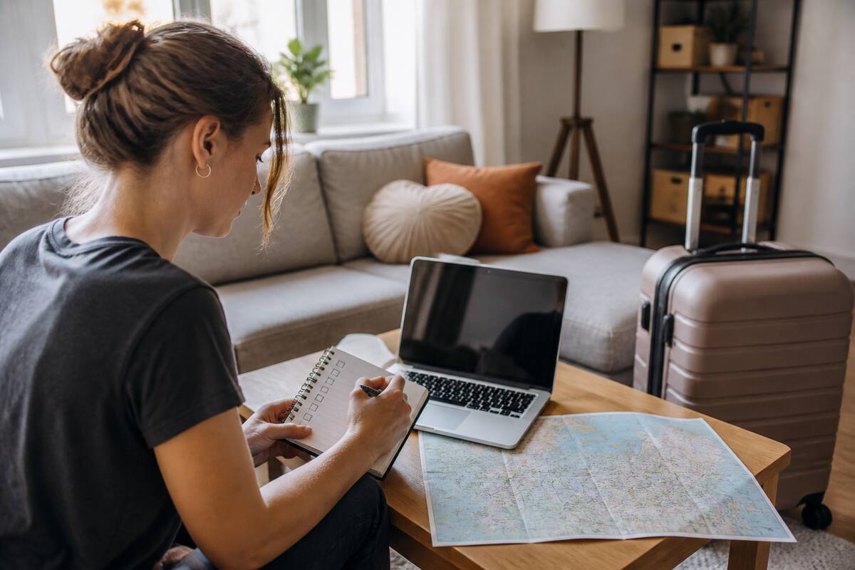 Persoon gebruikt een checklist op de laptop bij het vergelijken van vakanties